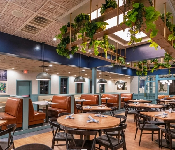 Layered lighting design creating comfortable dining zones in a human-centric restaurant environment