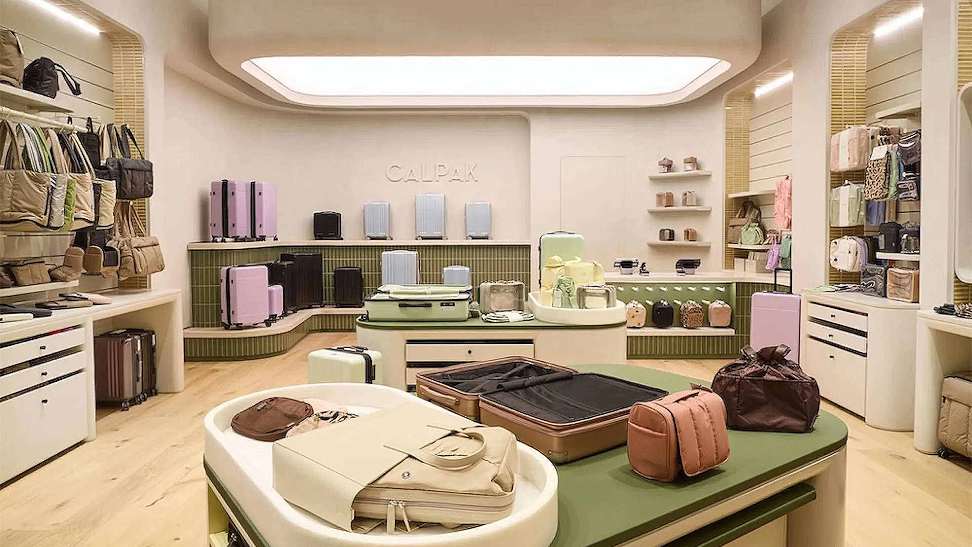Interior of CALPAK retail store at Century City Mall featuring rounded-edge LumiCloud Carra ceiling lights complementing curved travel accessories