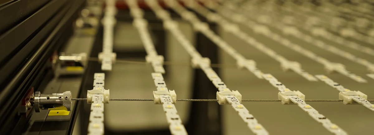 Behind the scenes during assembly: precision-tensioned cables and modular LED strips form the internal lattice of the TLS Lighting Solutions